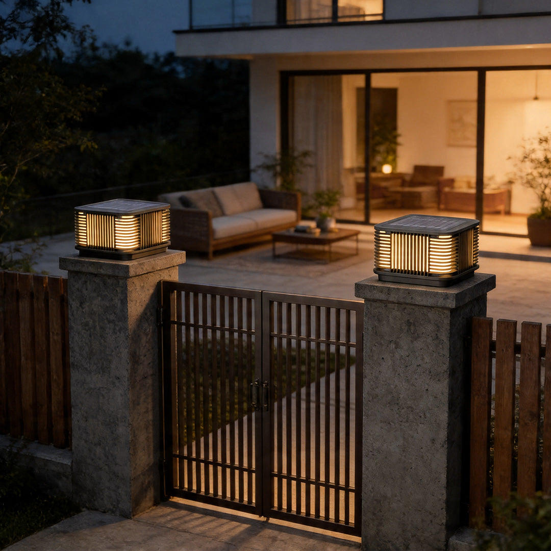 Pillar solar lights mounted on driveway gate columns creating elegant outdoor evening illumination.