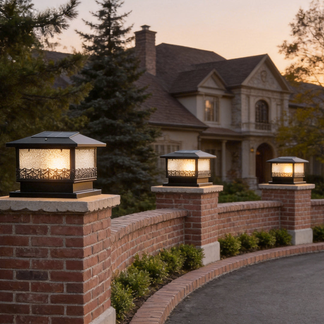 Pillar solar lights for outdoors mounted on brick columns along a driveway, creating elegant pathway lighting at dusk.