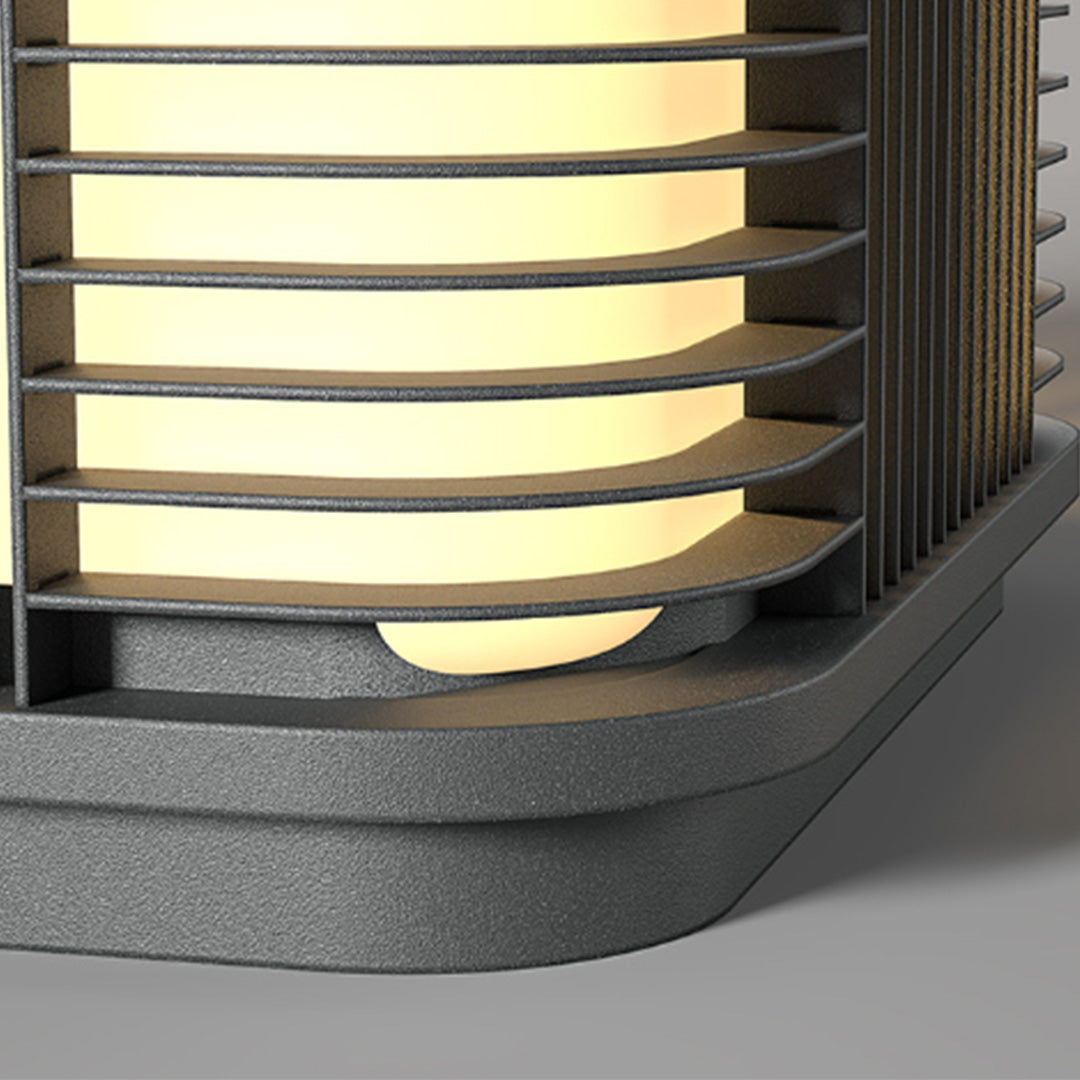 Close-up detail of pillar solar lights showing layered diffuser and textured metal frame design.