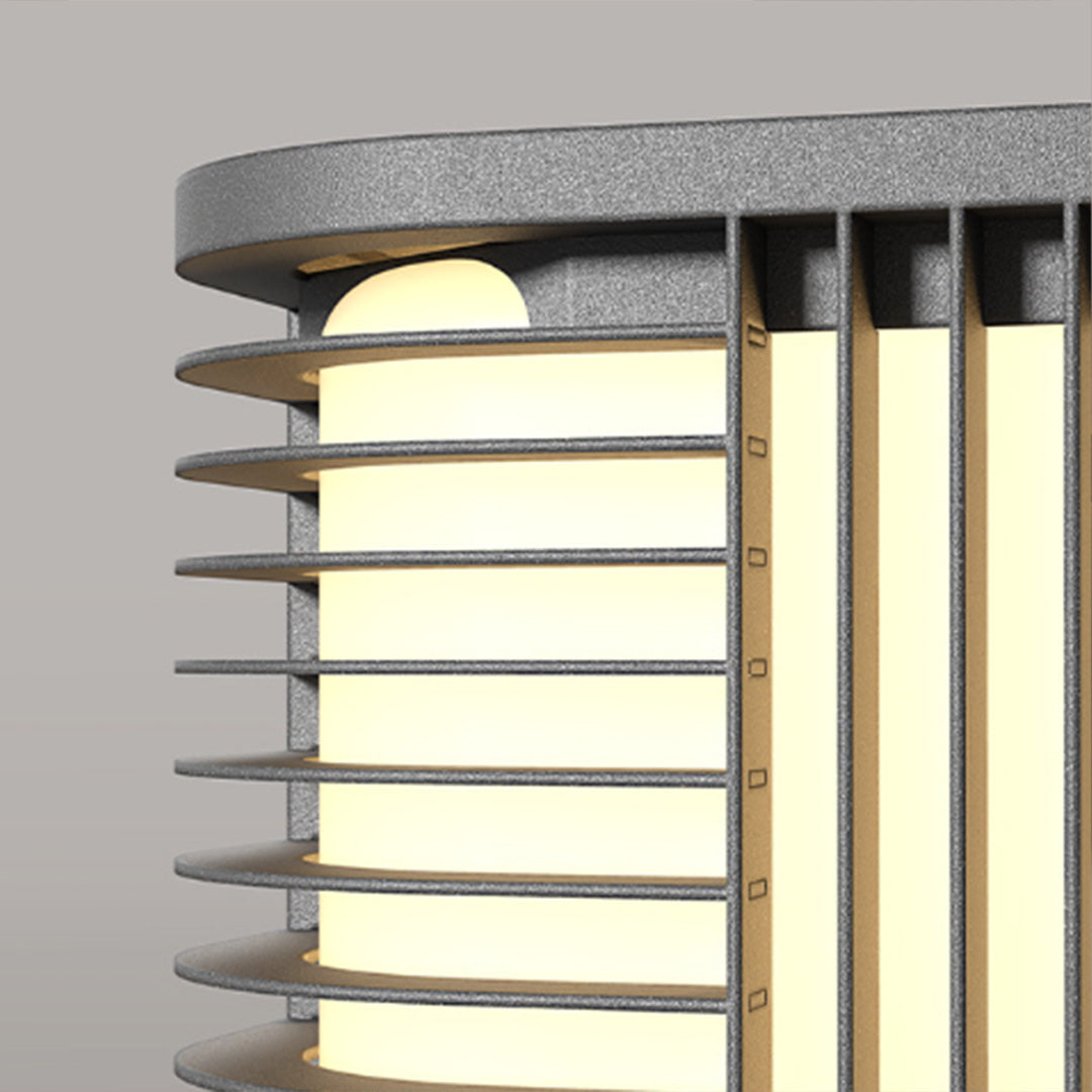 Pillar solar lights close-up featuring vertical metal bars and warm glowing LED illumination.
