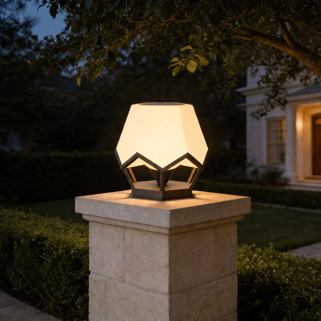 Pillar top solar lights on concrete garden pillar providing stylish landscape lighting at night.