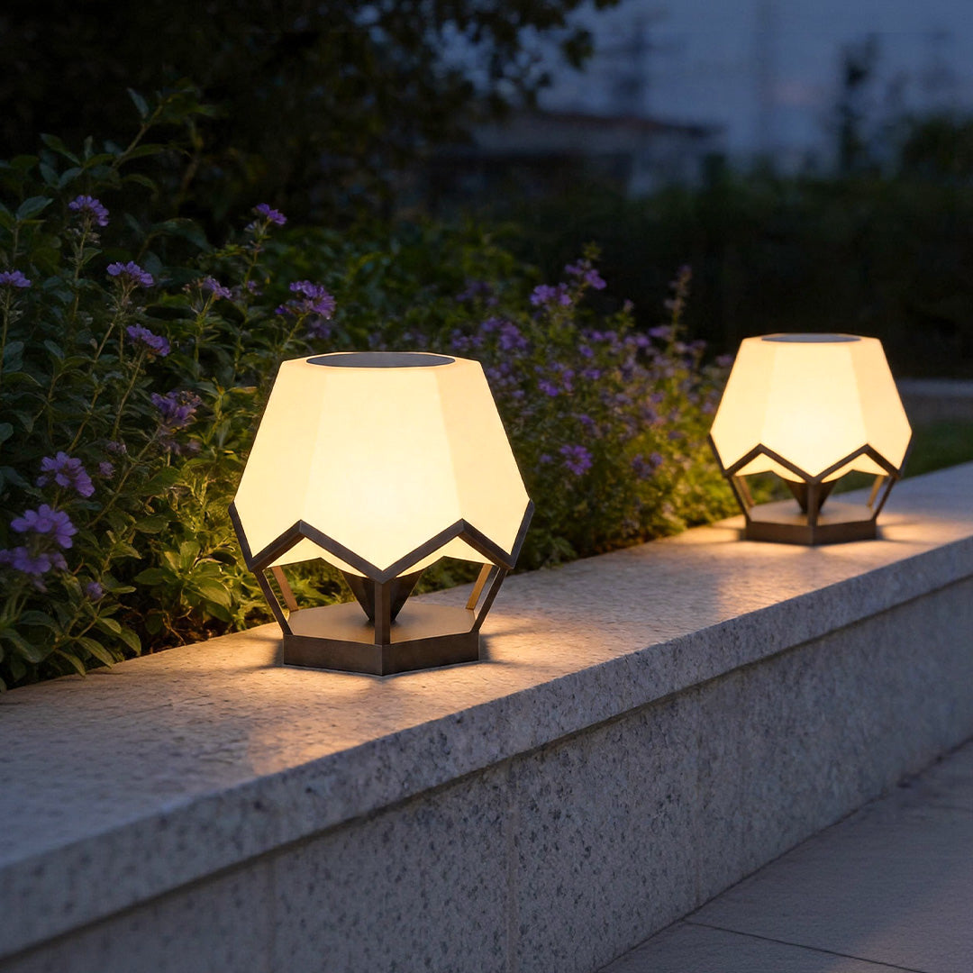 Pillar top solar lights installed on modern garden wall with warm decorative outdoor illumination.