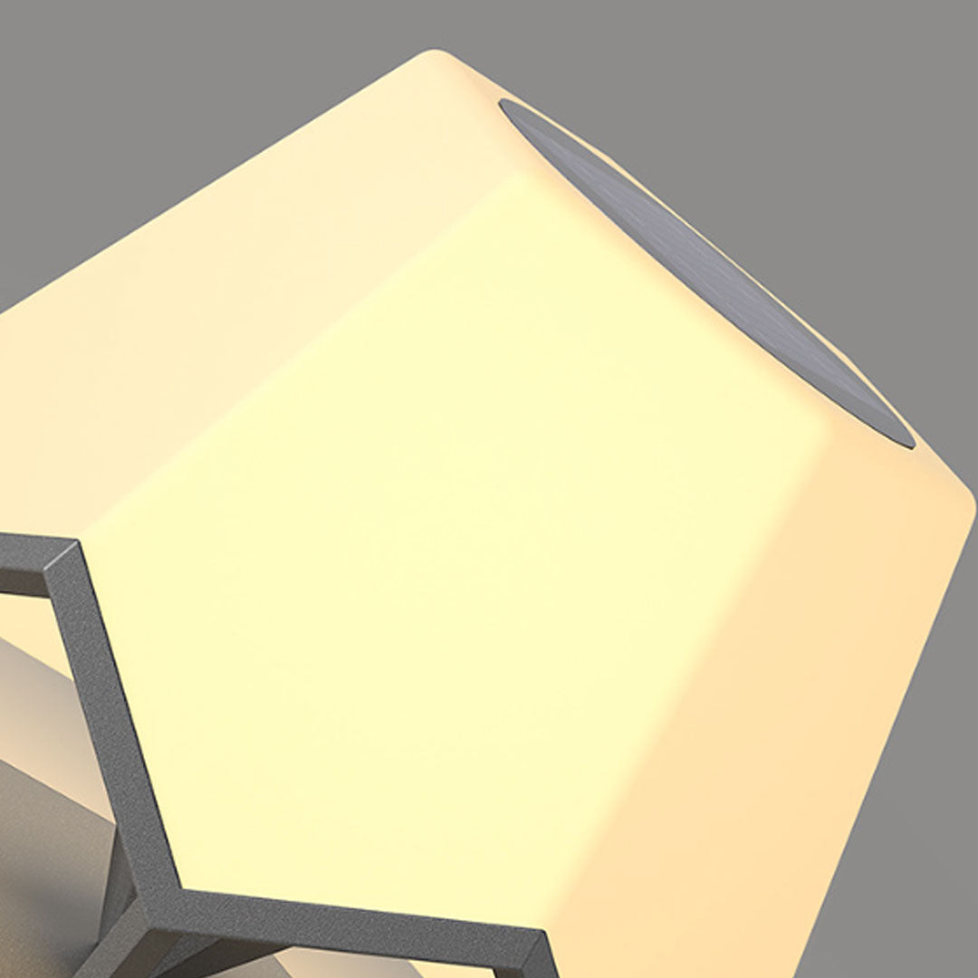 Pillar top solar lights close-up featuring illuminated geometric diffuser with warm LED lighting.