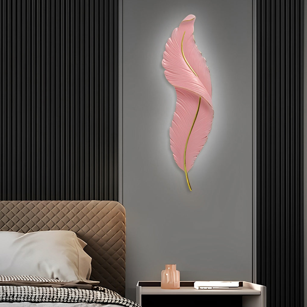 Pink feather wall light above bed creating soft decorative lighting in bedroom.