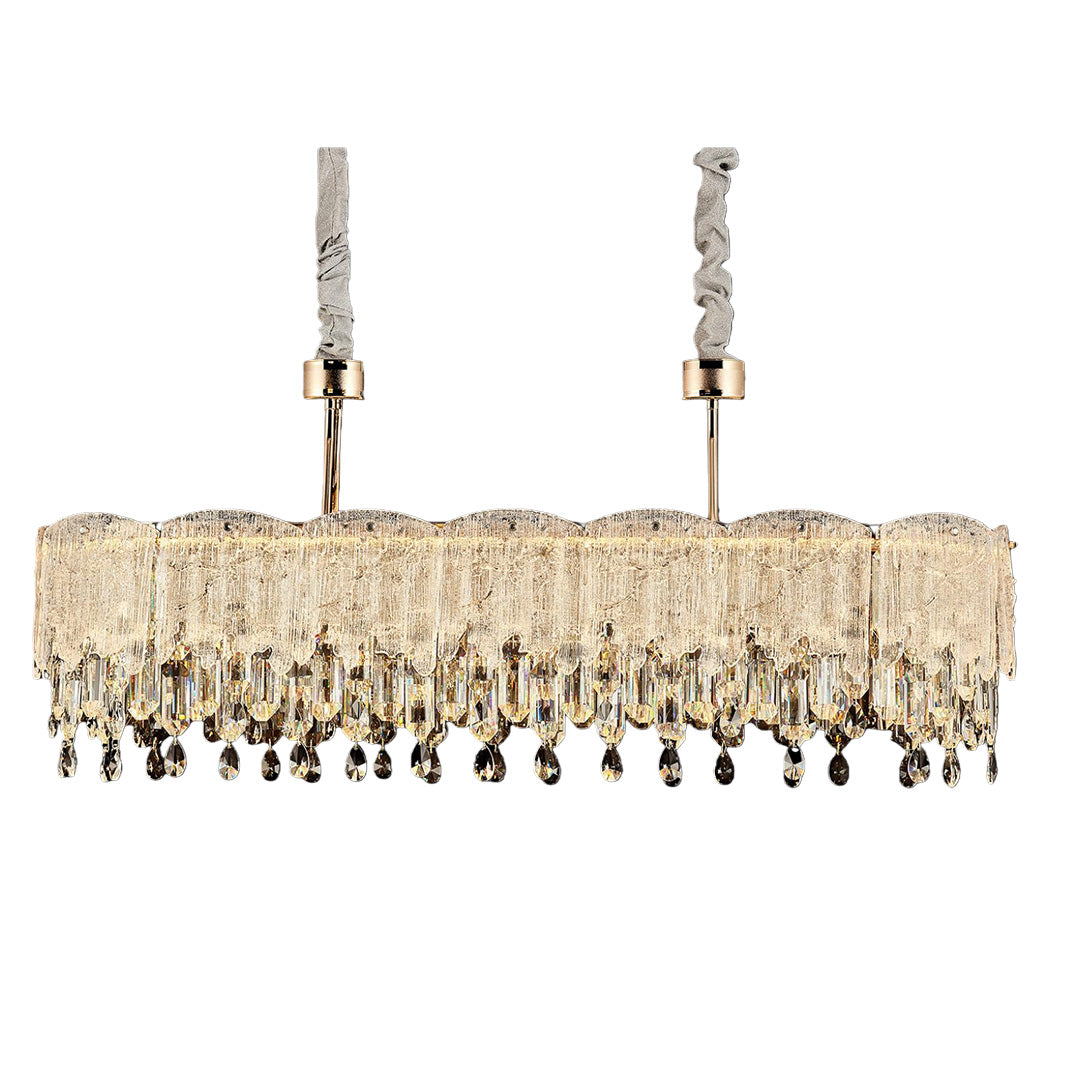 Dining room with pink glass fringe chandelier above marble table.