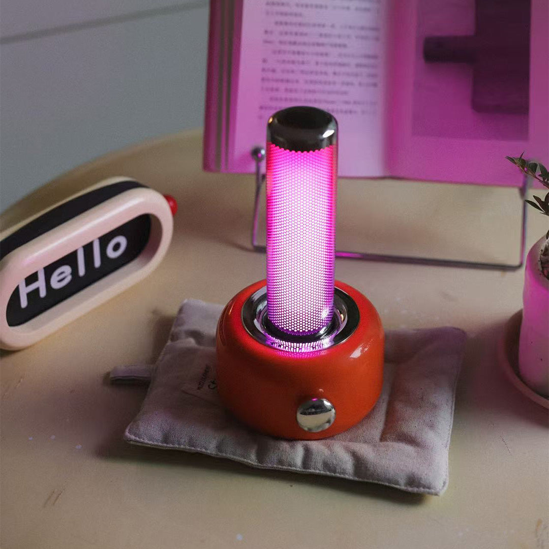 Pink industrial metal USB rechargeable table lamp creating colorful accent lighting indoors
