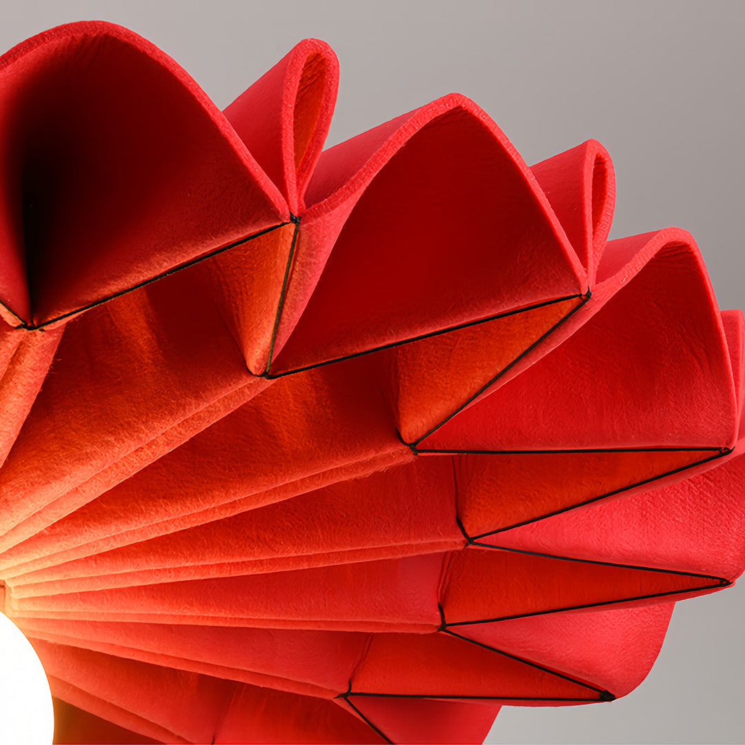Close-up macro shot of the pleated red cloth chandelier fabric texture and folding detail 