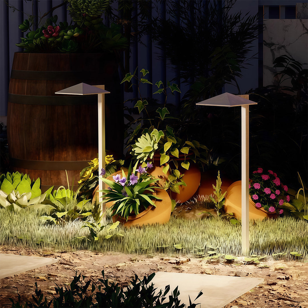 Plug-in pathway light placed near a wooden fence, enhancing the outdoor ambiance with subtle lighting.