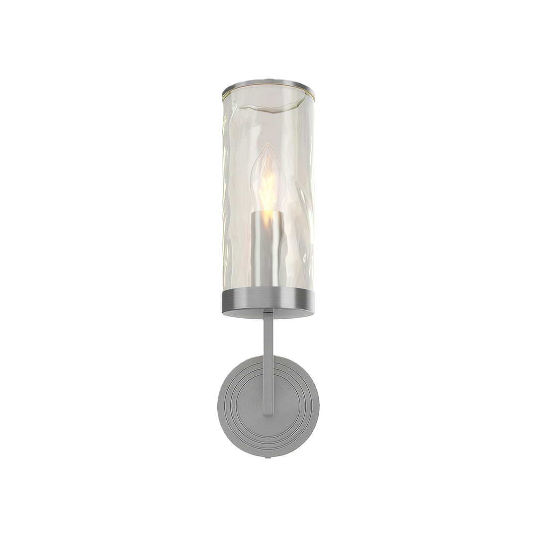 Wall glass light featuring polished chrome with clear glass cylinder and decorative backplate