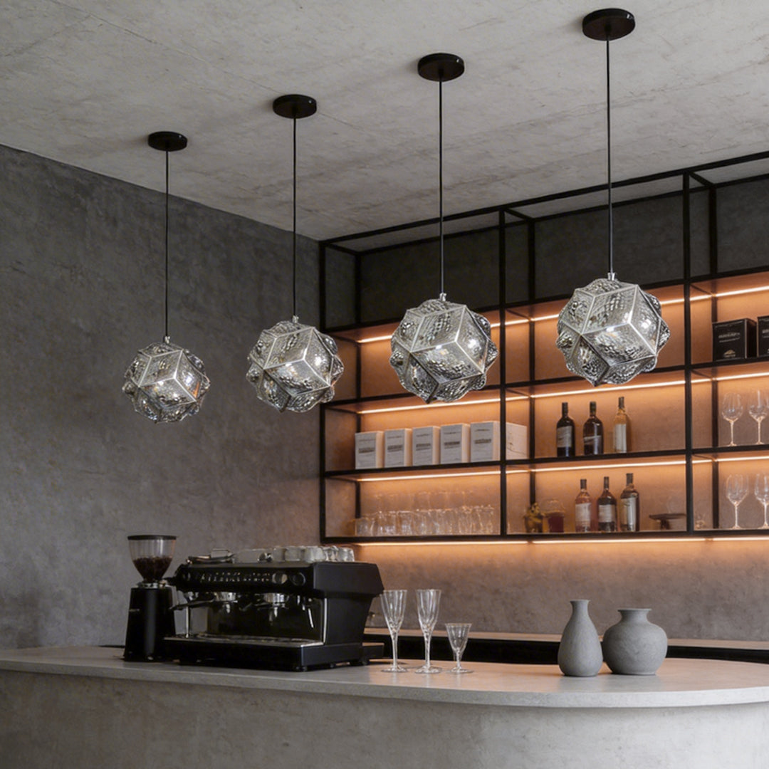 Polyhedron pendant light providing ambient illumination in a contemporary coffee shop.