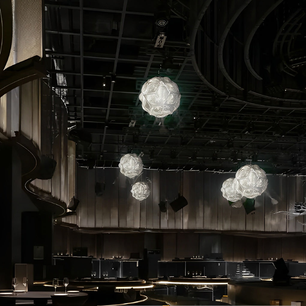 Polyhedron pendant light with a white finish, installed in a modern living room.