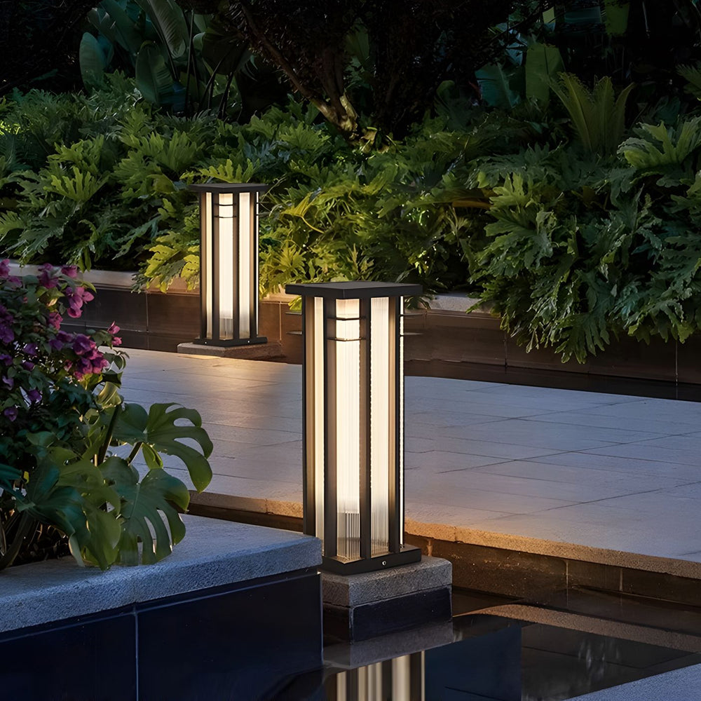 Elegant poolside lighting with matching bollard fixtures creating sophisticated ambiance beside water feature