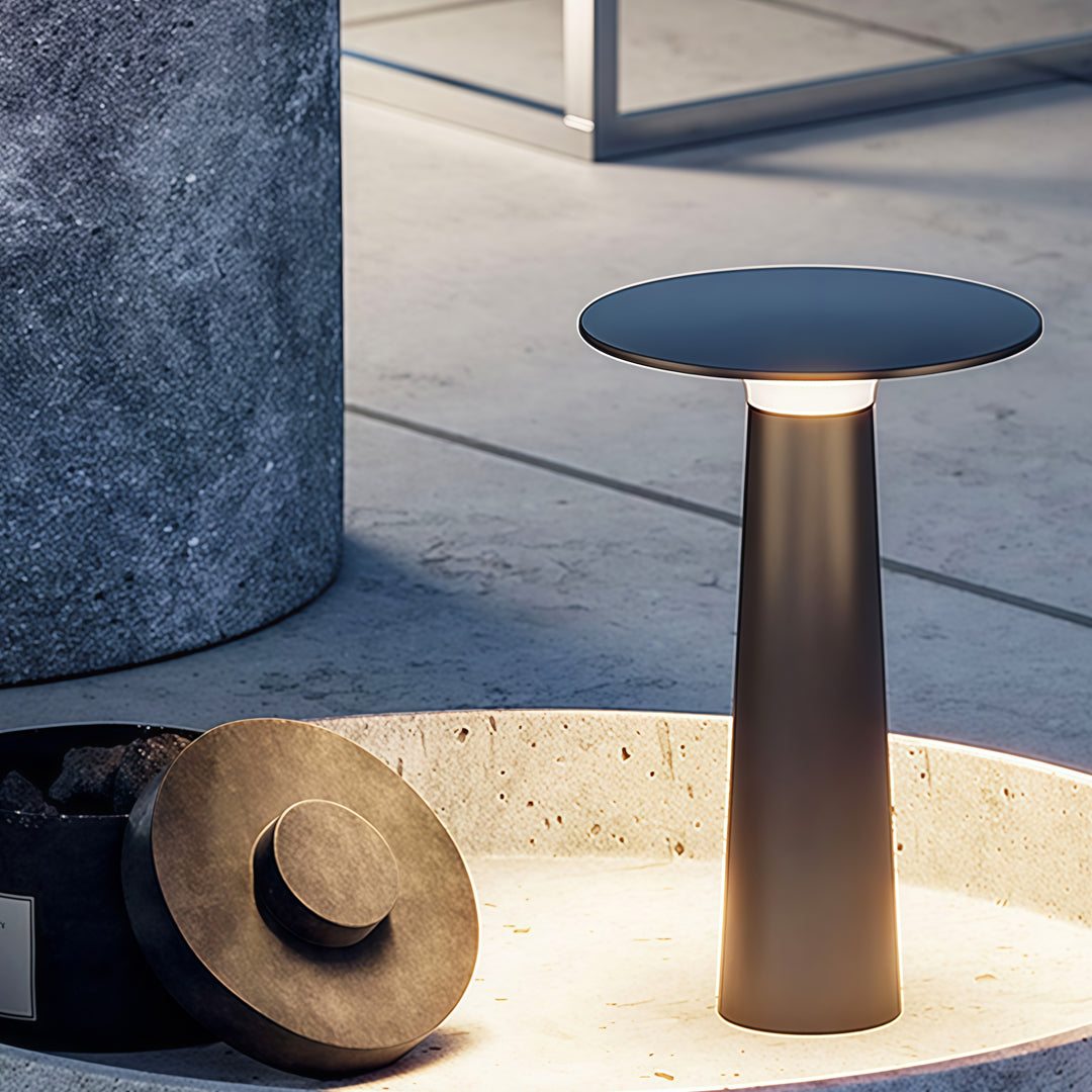 Brown outdoor led table lamp placed beside a poolside pathway providing warm ambient glow.