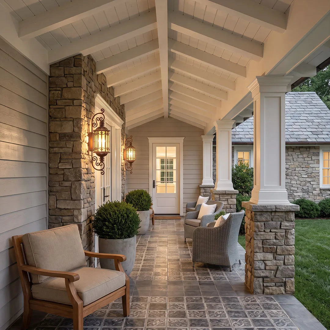 Vintage wall sconce lighting mounted along a covered porch with warm decorative illumination.