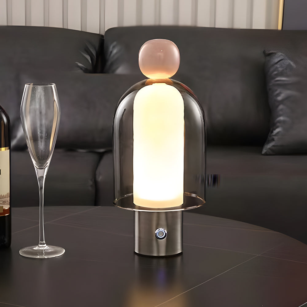 Portable glass table light enhancing a contemporary living room with elegant, minimalist design.