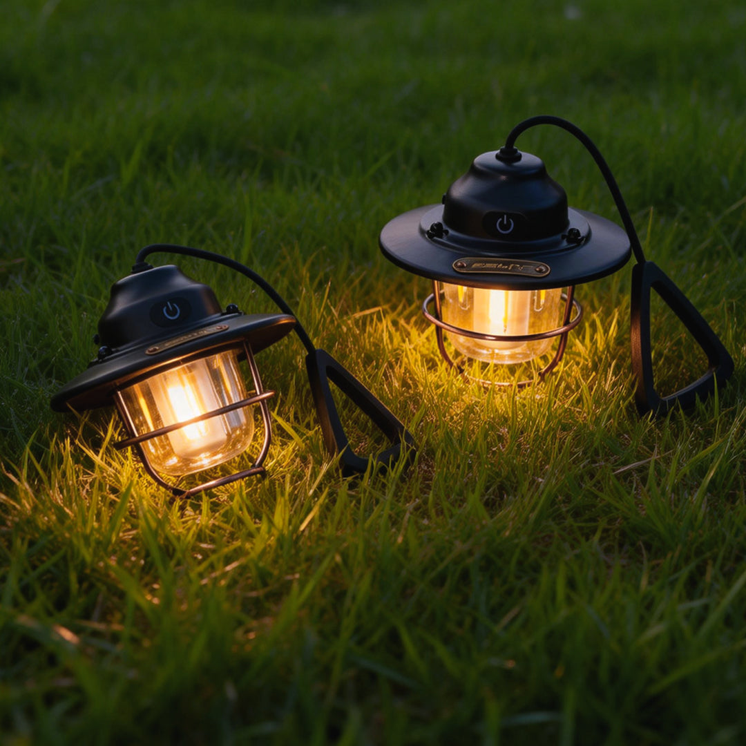 Portable hanging light casting warm light on the grass, perfect for outdoor camping ambiance.