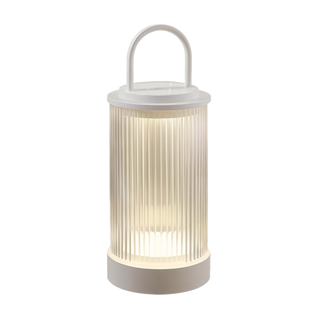 Portable lantern positioned on raised deck area with surrounding plants during evening.