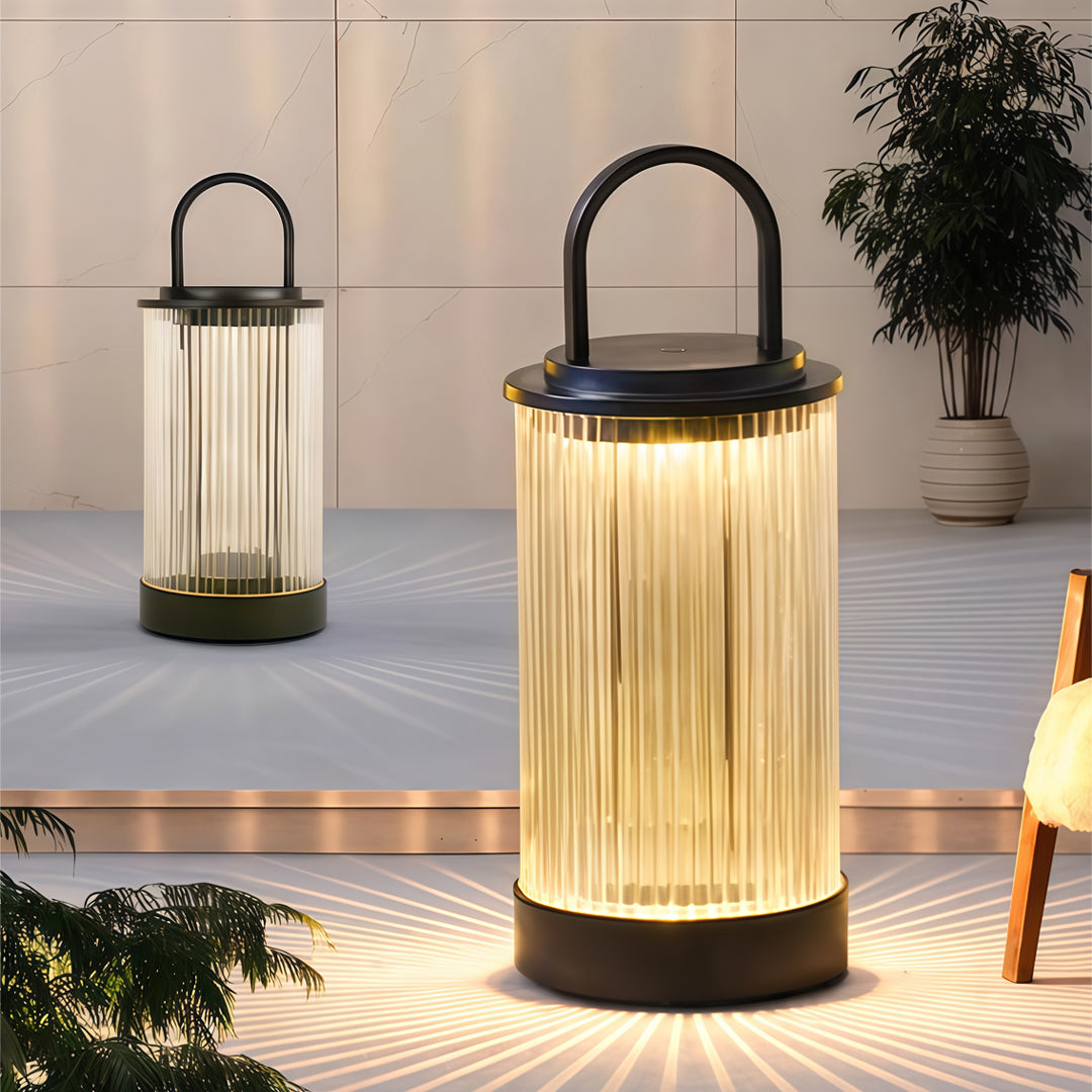 Tall portable lantern lighting a wooden deck area during dusk, creating a cozy ambient atmosphere.