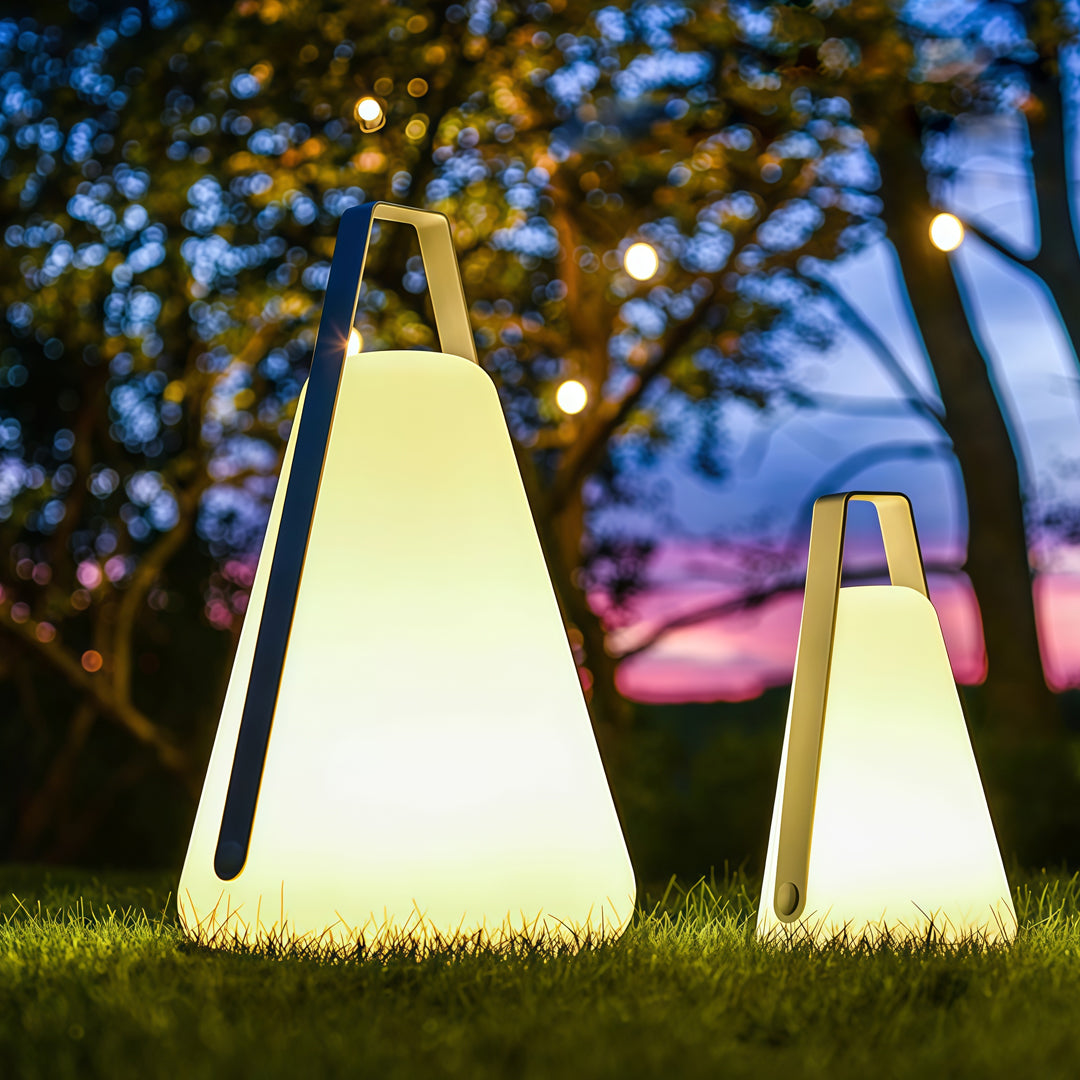 A group of bright portable led lanterns glowing at dusk in a park setting, enhancing the outdoor atmosphere with warm light.