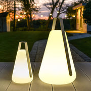 Two portable led lanterns of different sizes arranged on a pathway at sunset, providing warm and decorative portable lighting.