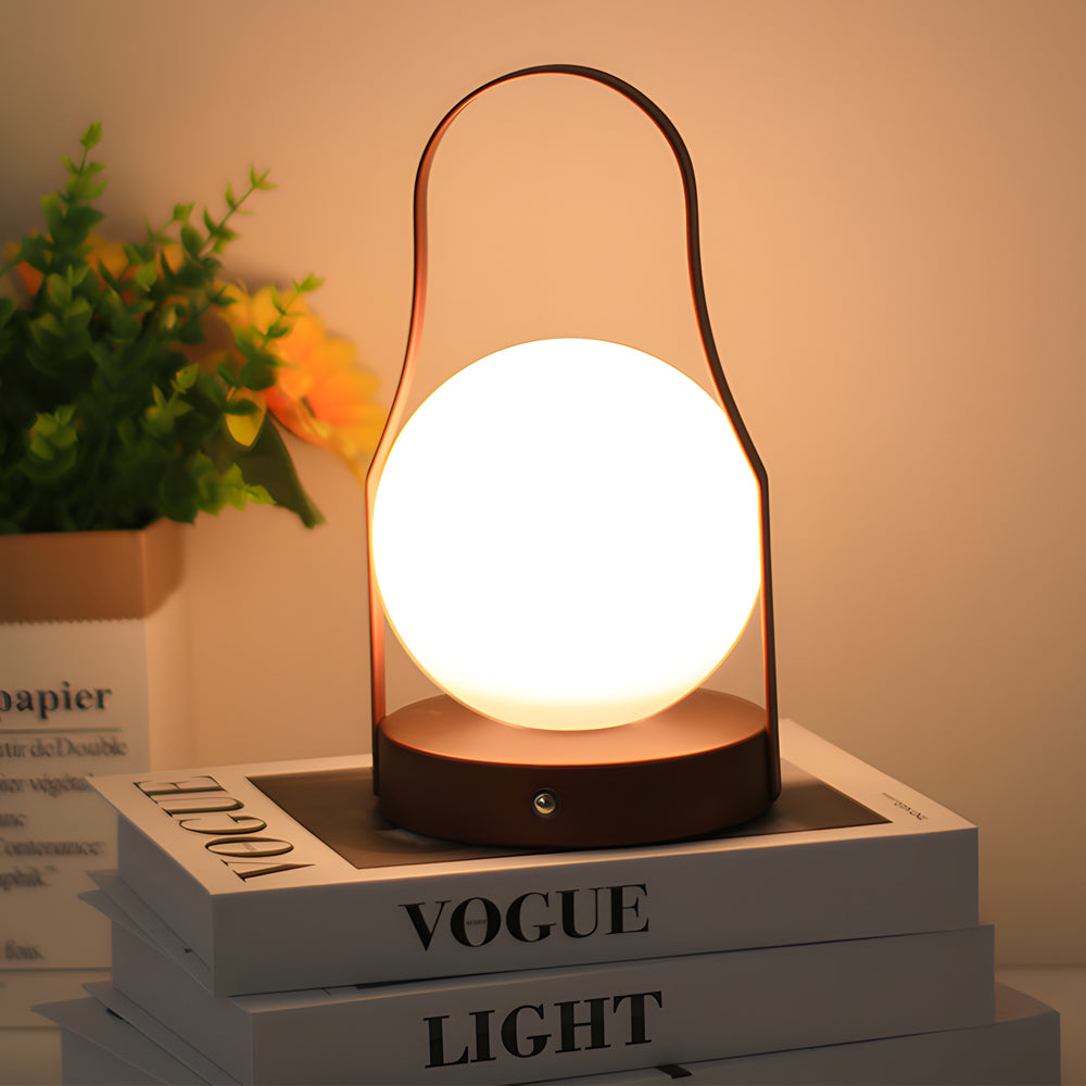 Portable rechargeable LED lantern casting a gentle glow on a stack of books.