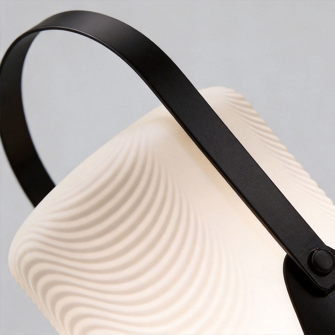 Portable solar lanterns with a modern design, illuminating a garden pathway.