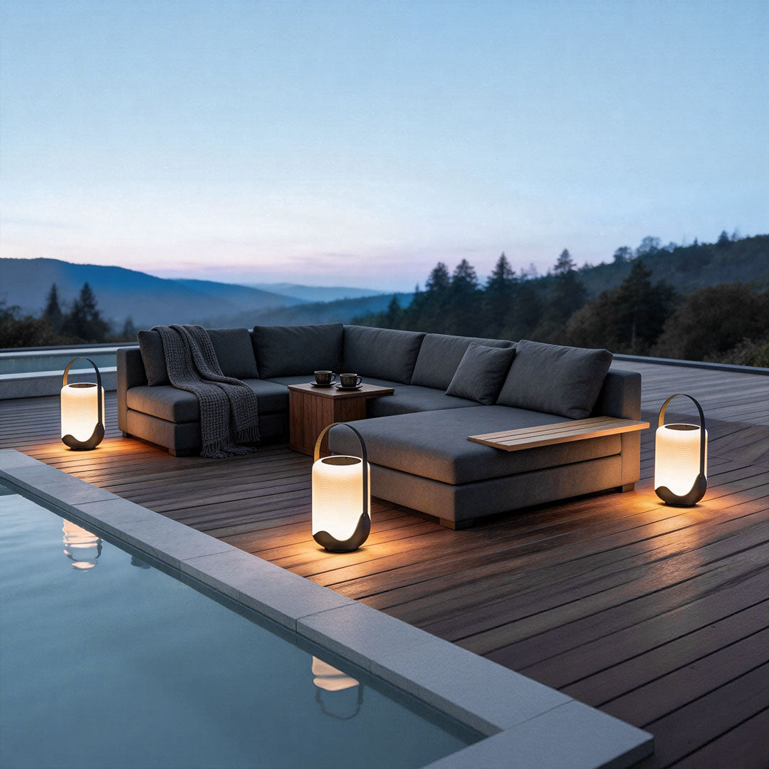 Portable solar lanterns with a sleek design, illuminating a poolside seating area.