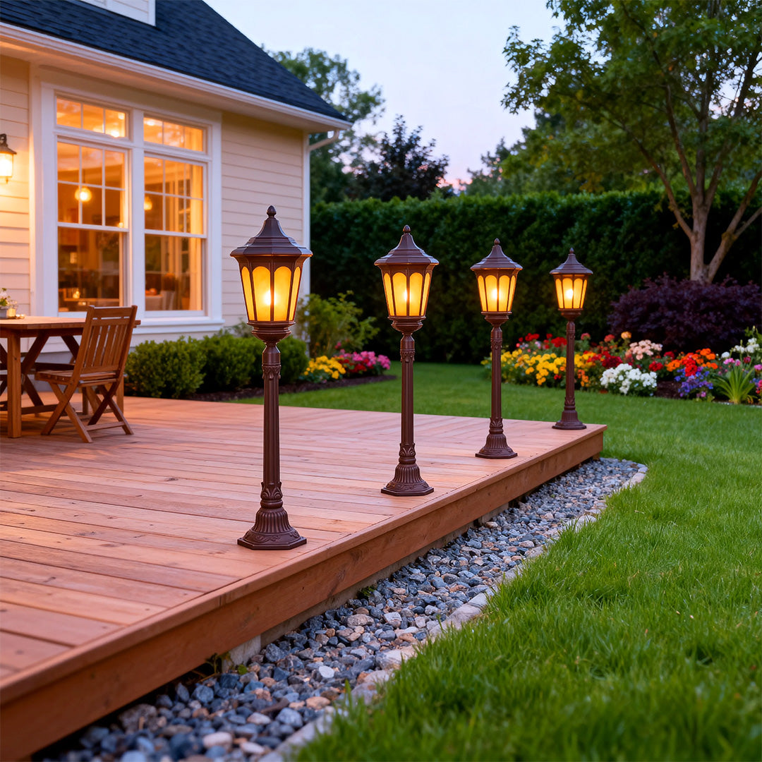 Multiple post path lights lining brick patio and lawn area creating ambient outdoor lighting at twilight