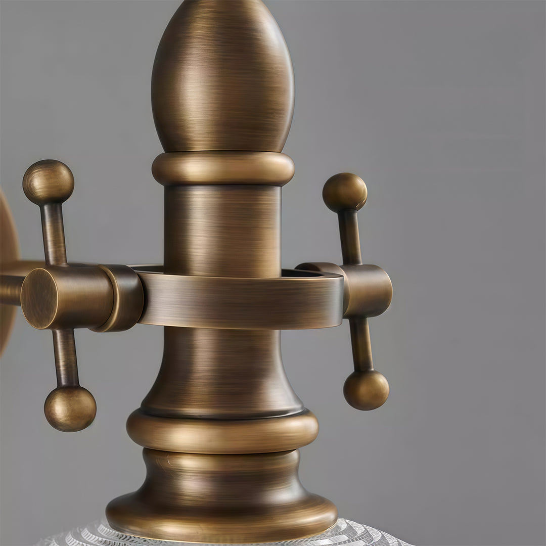 Product detail of indoor wall mount lights featuring glass shade chandelier aesthetic showing vintage brass gooseneck arm construction.