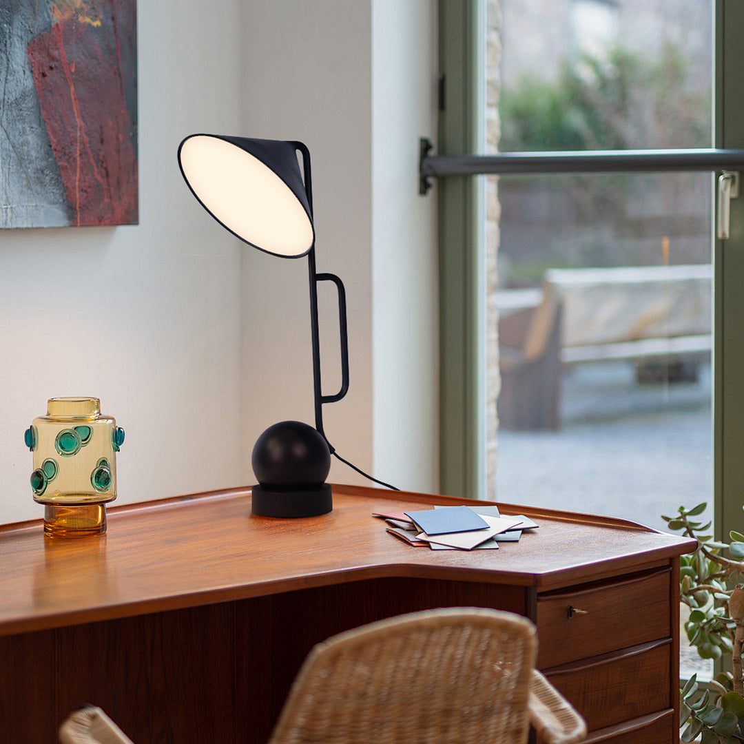 Professional black metal desk lamp with USB rechargeable base providing focused task lighting