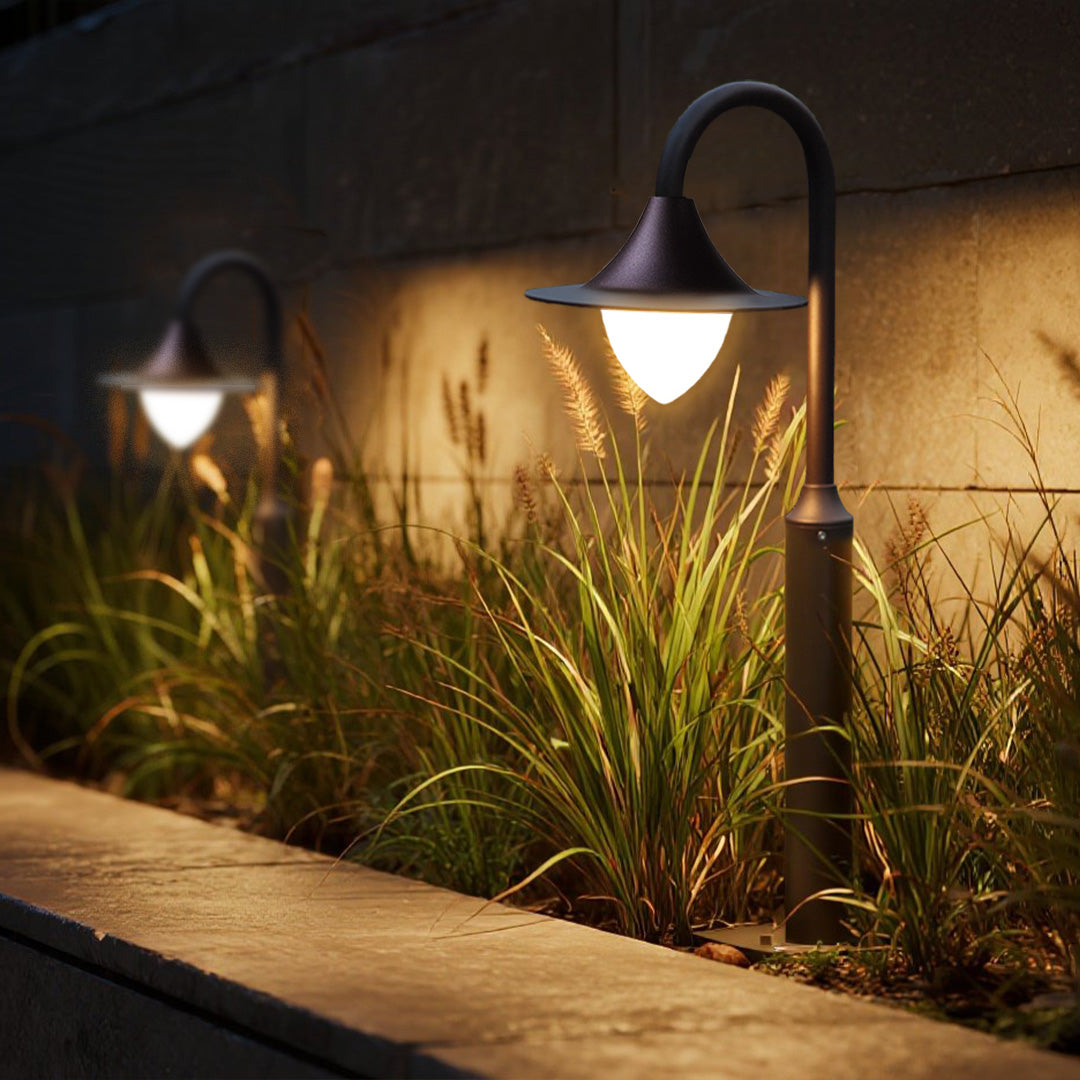Professional landscape design showcasing multiple shepherd's hook lights among ornamental plantings