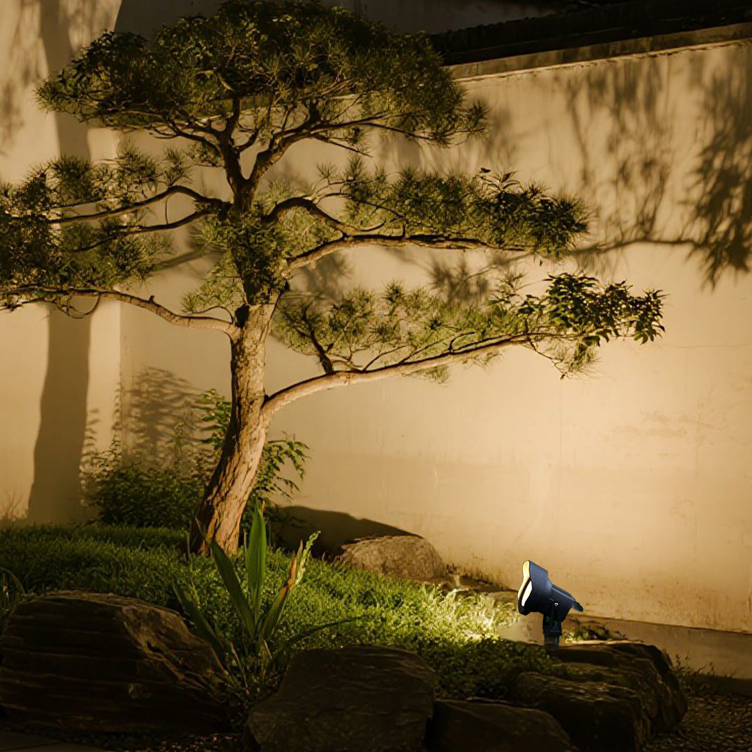 Professional uplighting showcasing trees and architectural elements in contemporary residential landscape design