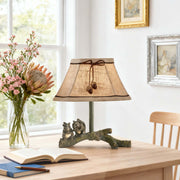 Quaint squirrel table lamp with a textured shade and rustic branch base, adding a nature-inspired element to a sunny room.