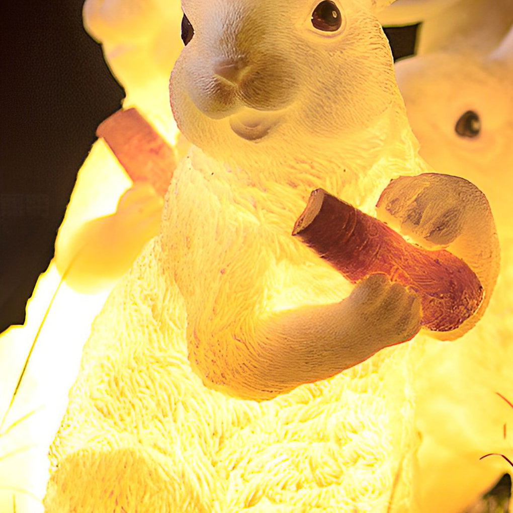 Detailed view of a rabbit garden light with a carrot, showcasing its intricate design and texture.