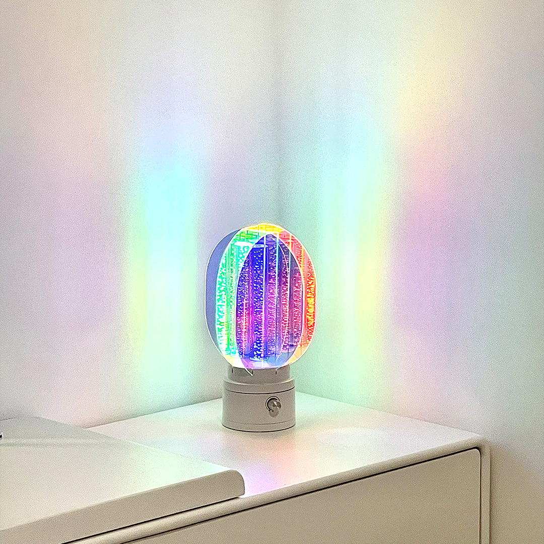 Vibrant colourful table lamps creating rainbow light projection with dichroic glass shade technology