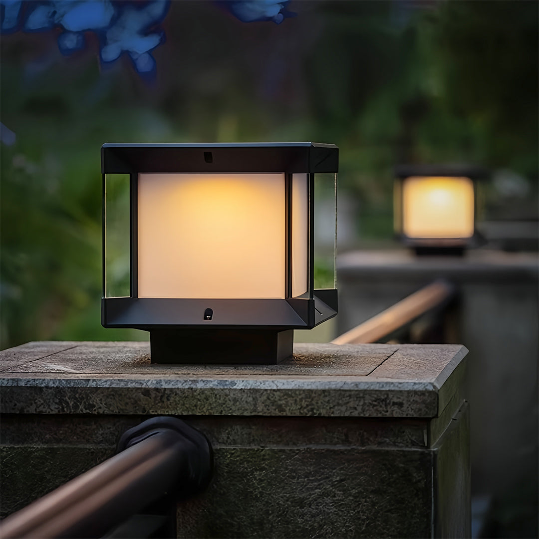 Pillar lights outdoor modern glowing in a rainy nighttime scene on a stone wall.