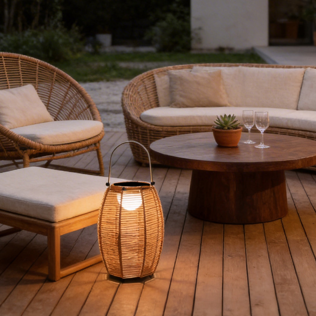 Rattan floor lantern enhancing a modern patio table setting with elegant light.