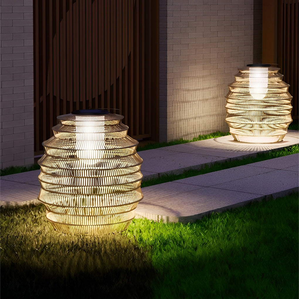 Rattan outdoor lantern with a close-up of its intricate woven pattern and soft glow.