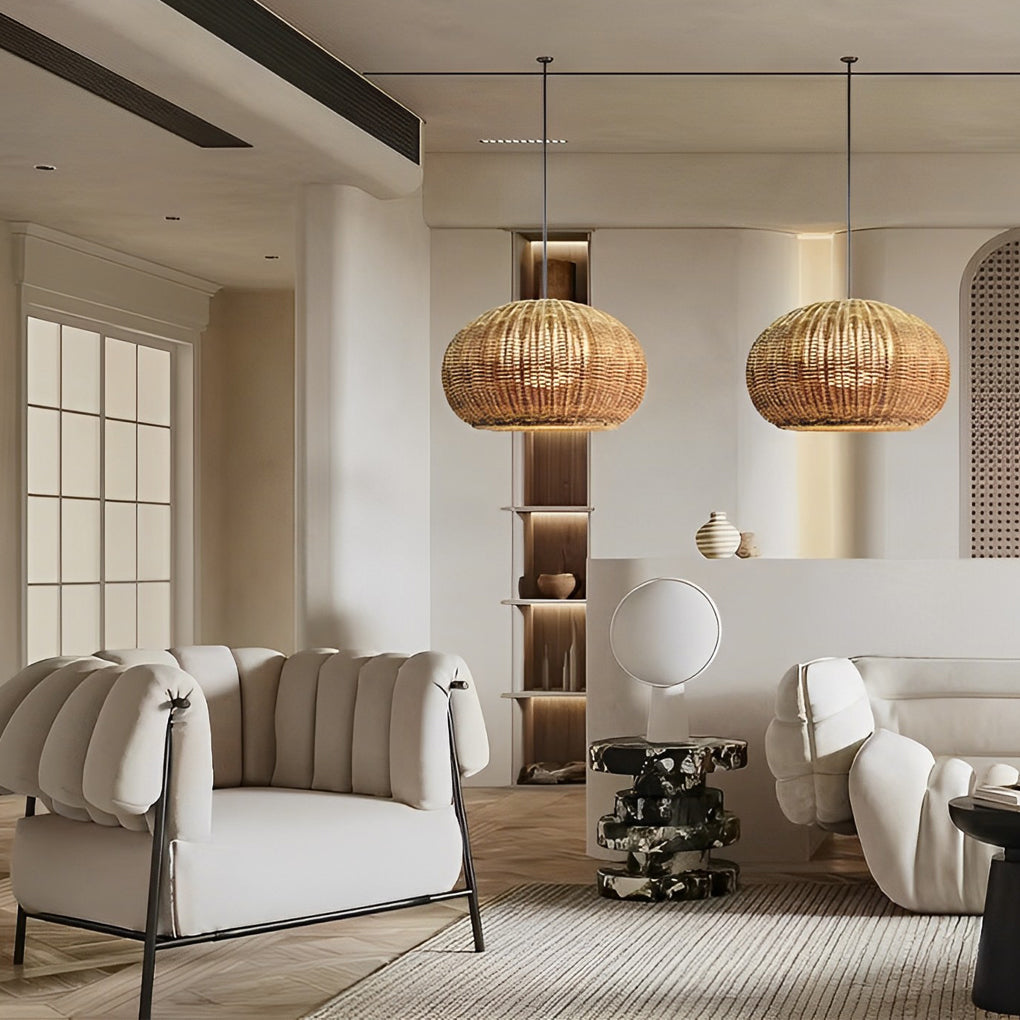 Rattan outdoor pendant light providing soft illumination in a beachside setting at sunset.