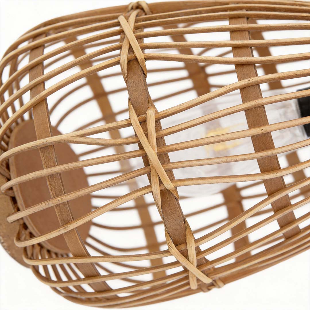 Rattan solar lantern with a close-up of its handle and glowing interior.