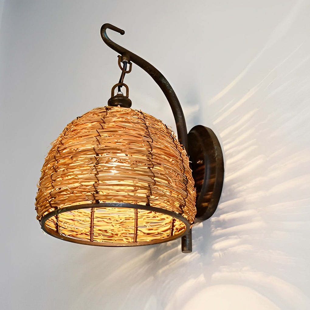 Rattan wall lamp with a black finish, providing ambient light in a reading nook.