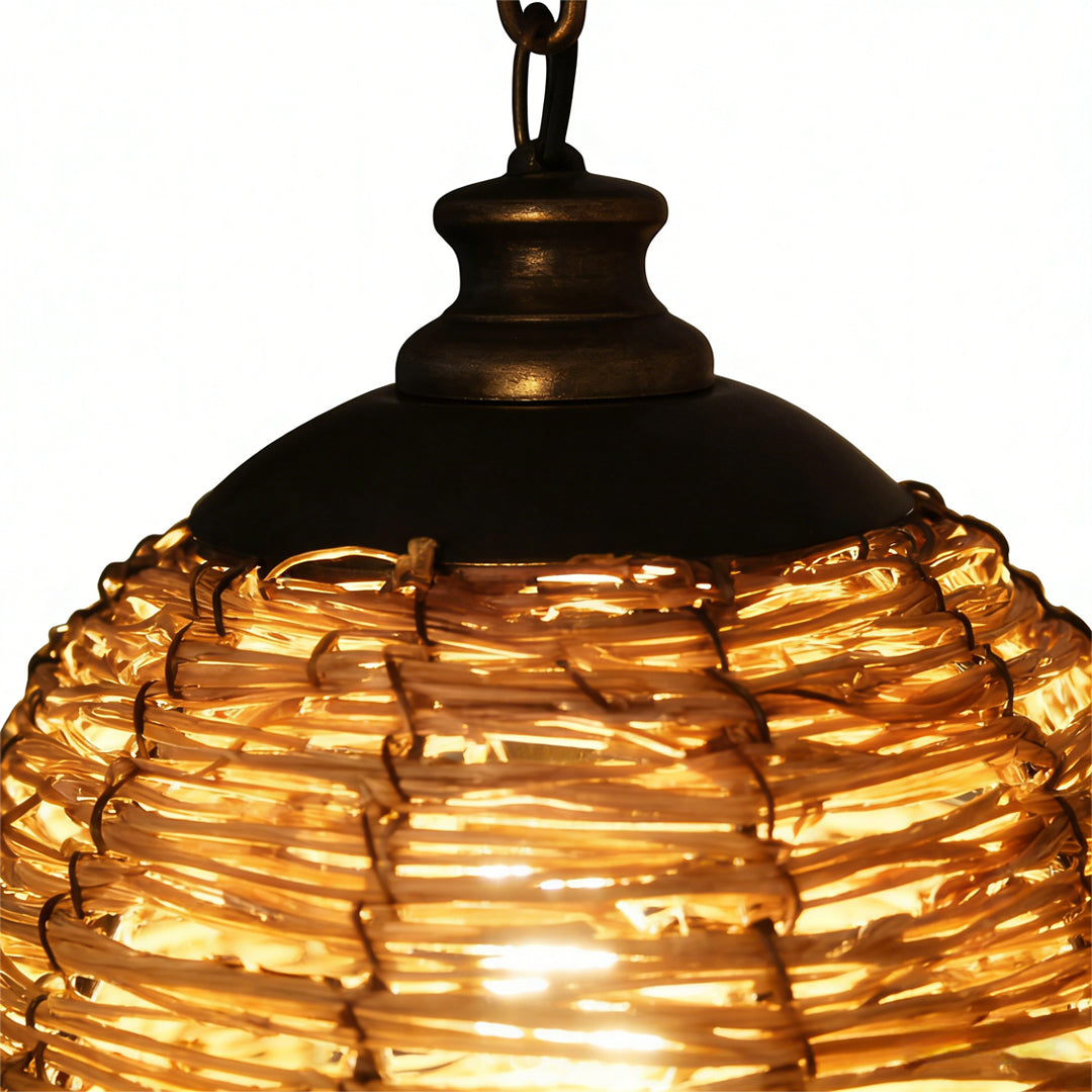 Rattan wall lamp with a black metal arm, providing warm light in a hallway.