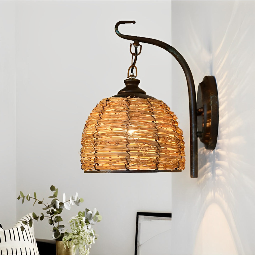 Rattan wall lamp with a rustic design, mounted beside a window.