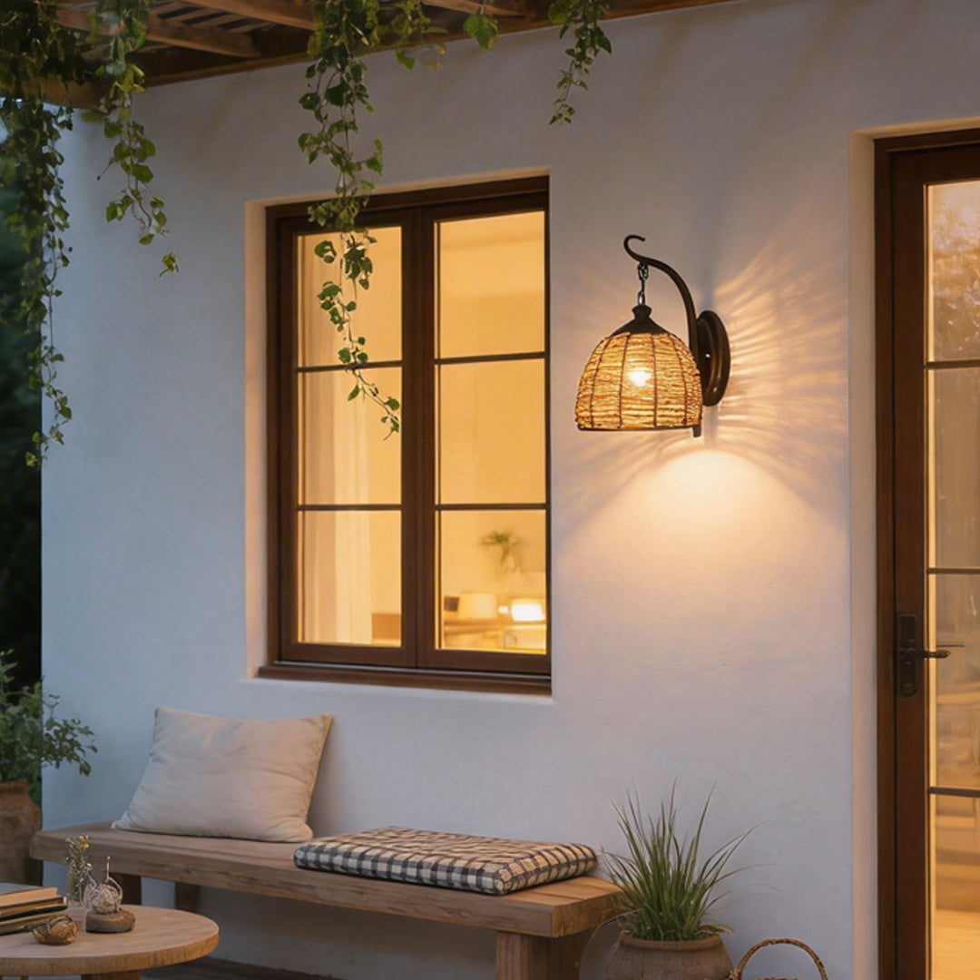 Rattan wall lamp with a vintage design, providing warm illumination in a cozy hallway.