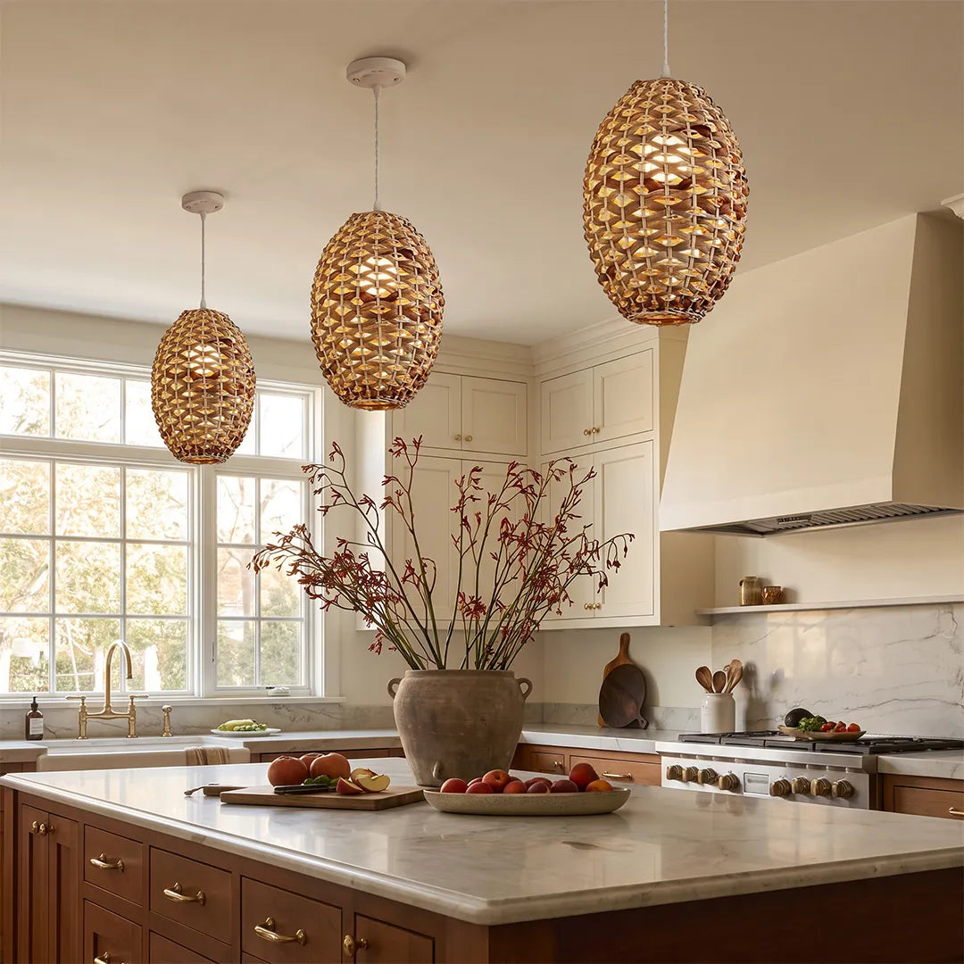 Rattan wicker pendant lights hanging above a kitchen island in a bright modern farmhouse kitchen.