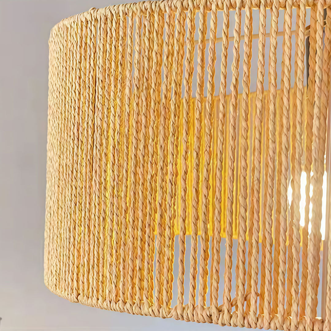 Rattan woven pendant light close-up showing detailed weaving texture and warm light diffusion.