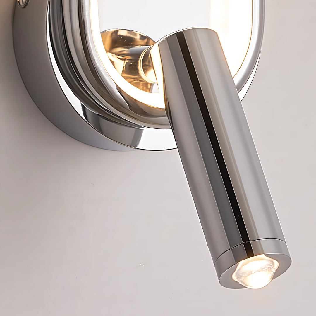 Close-up detail of reading light for bed wall mounted with chrome spotlight and circular LED ring.