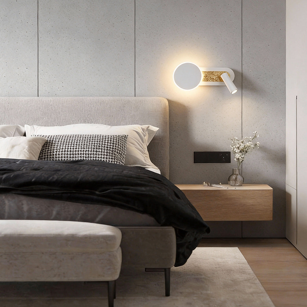 Reading light for bed wall mounted above a cozy bed with black and white bedding.