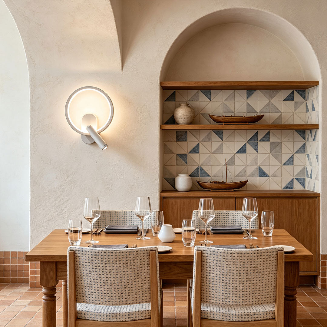 Elegant reading light for bed wall mounted in dining space with warm circular LED wall fixture.