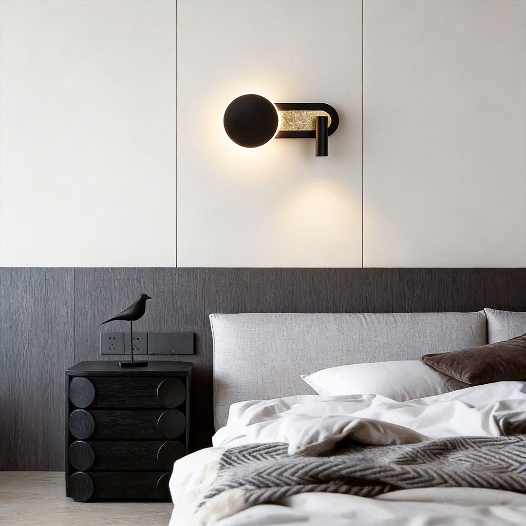 Reading light for bed wall mounted, casting focused light in a modern bedroom with gray accents.